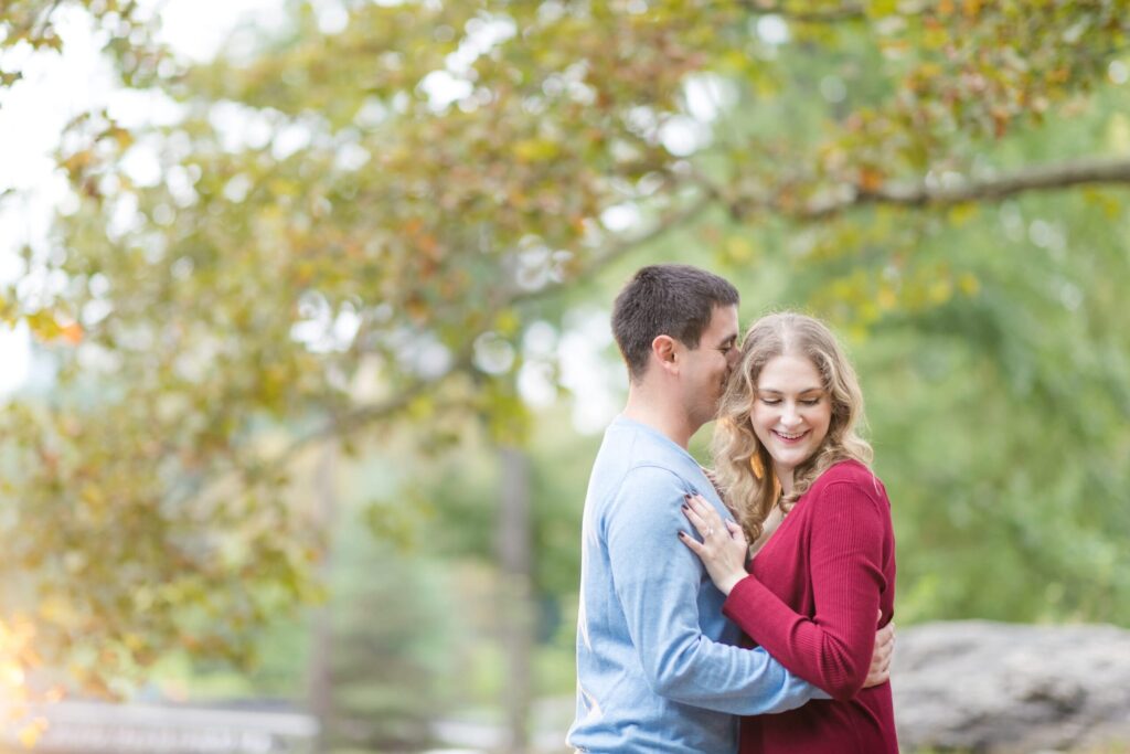 groom cuddling with bride to be in NYC