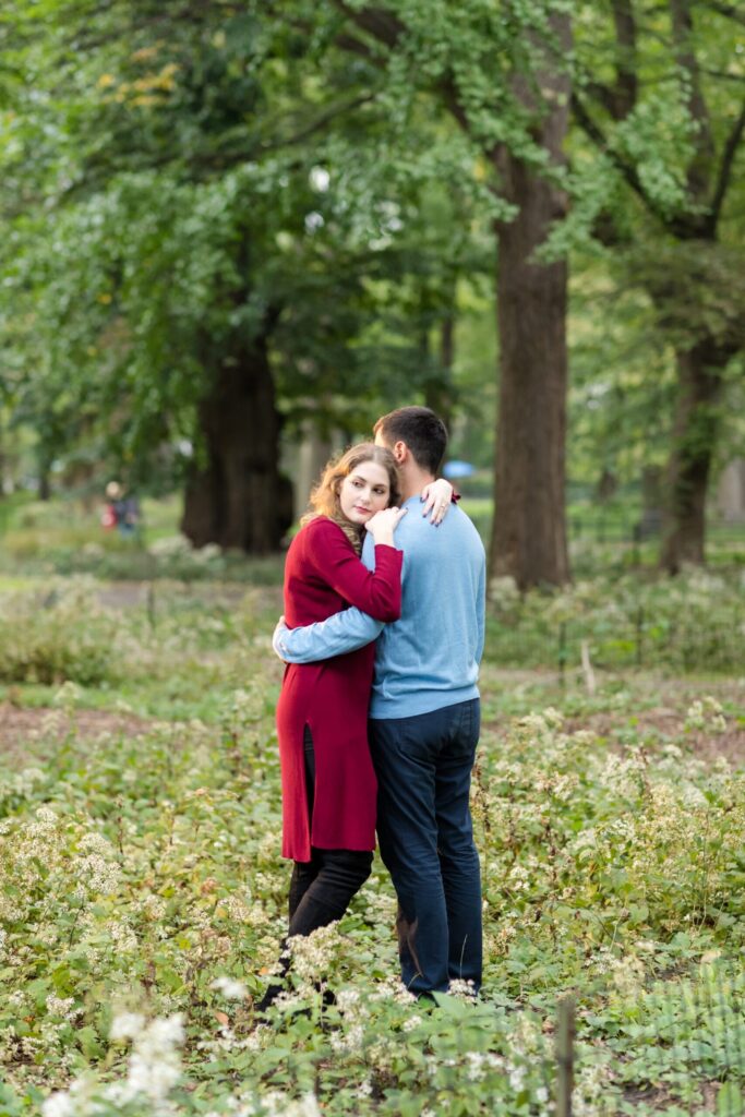 bride and groom to be stand in greenery