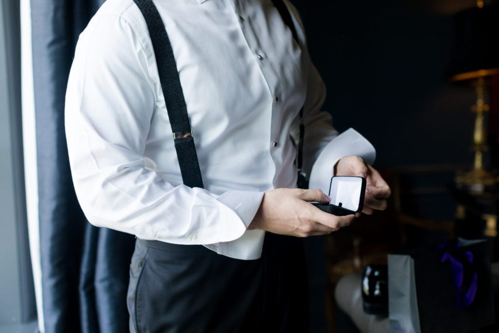 groom prepping to put on cufflinks