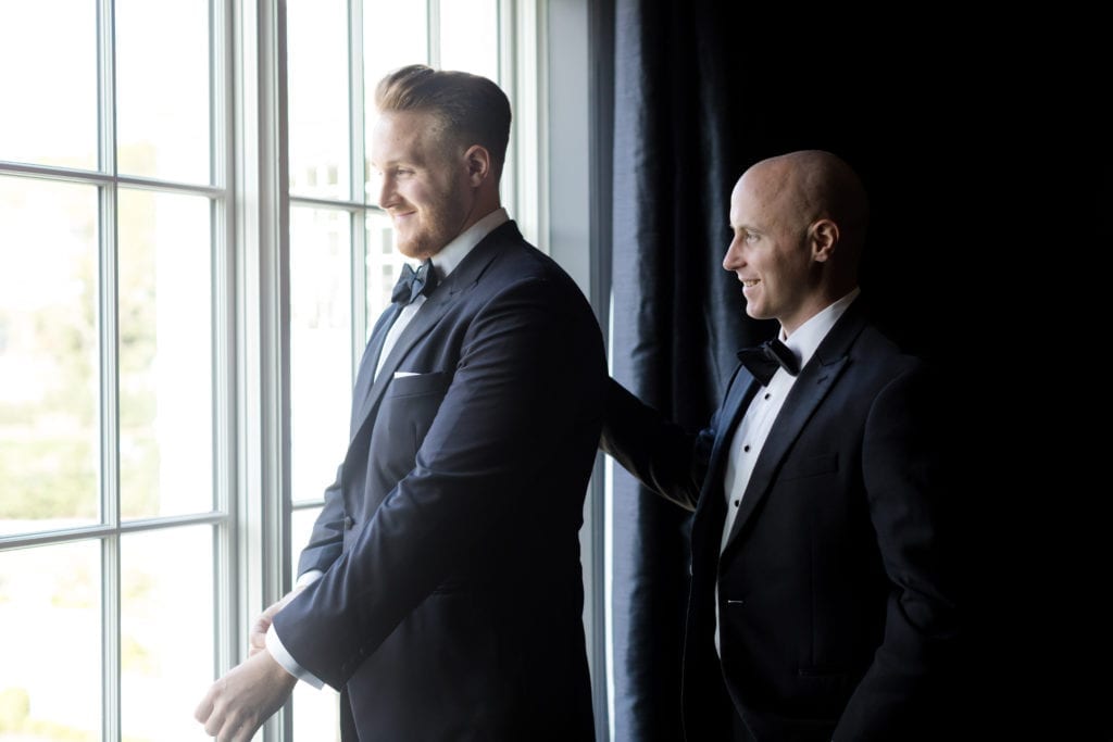 groom getting pep talk from best man