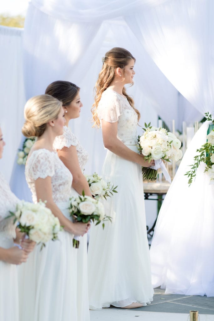 bridesmaids watching on at wedding ceremony