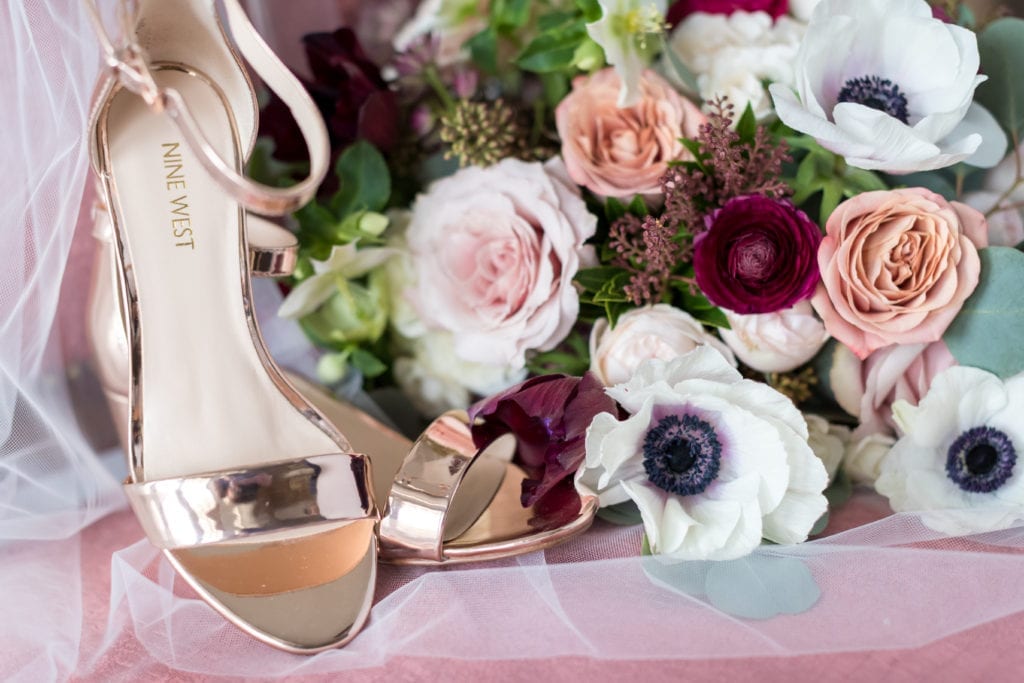 Close up shot of nine west shoes and Cassandra Shah Flowers and Event Design floral bouquet 