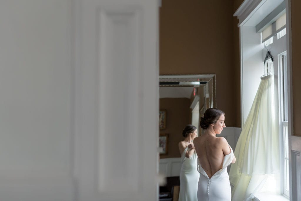 bride getting into her Pronovias wedding dress