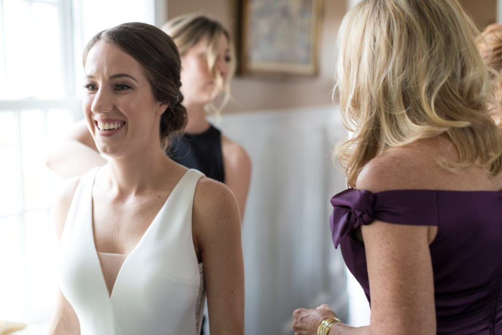 bride sharing a smile while getting ready for her wedding day