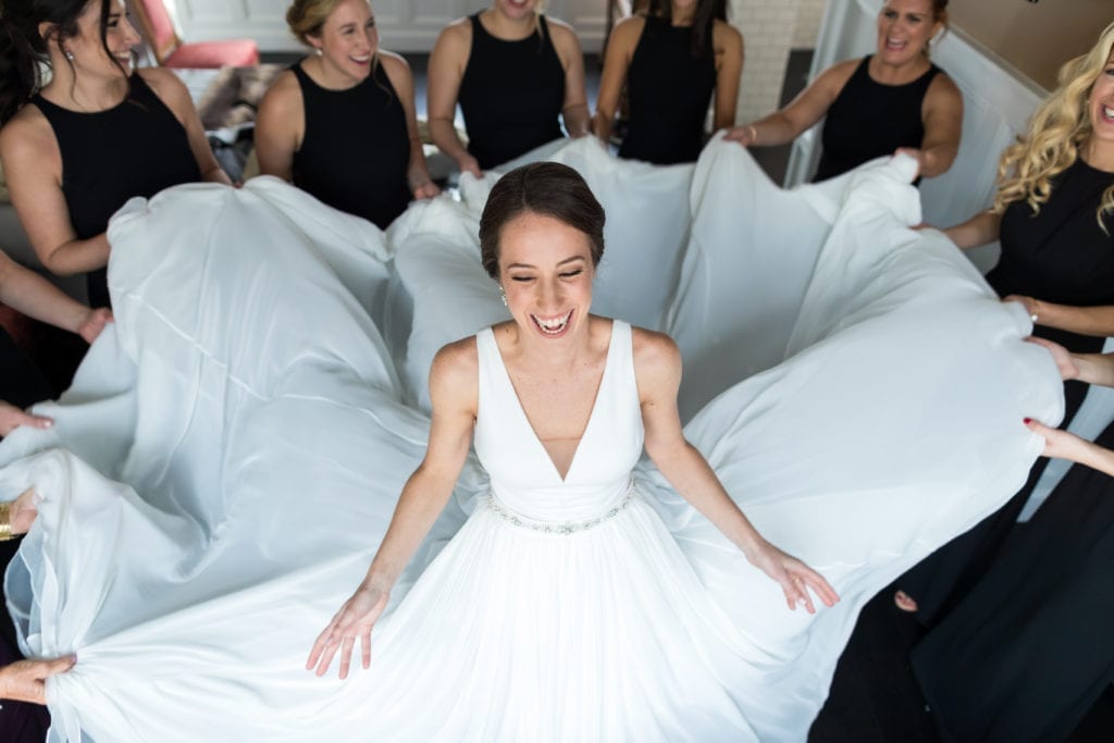 bridesmaids holding onto brides Pronovias veil