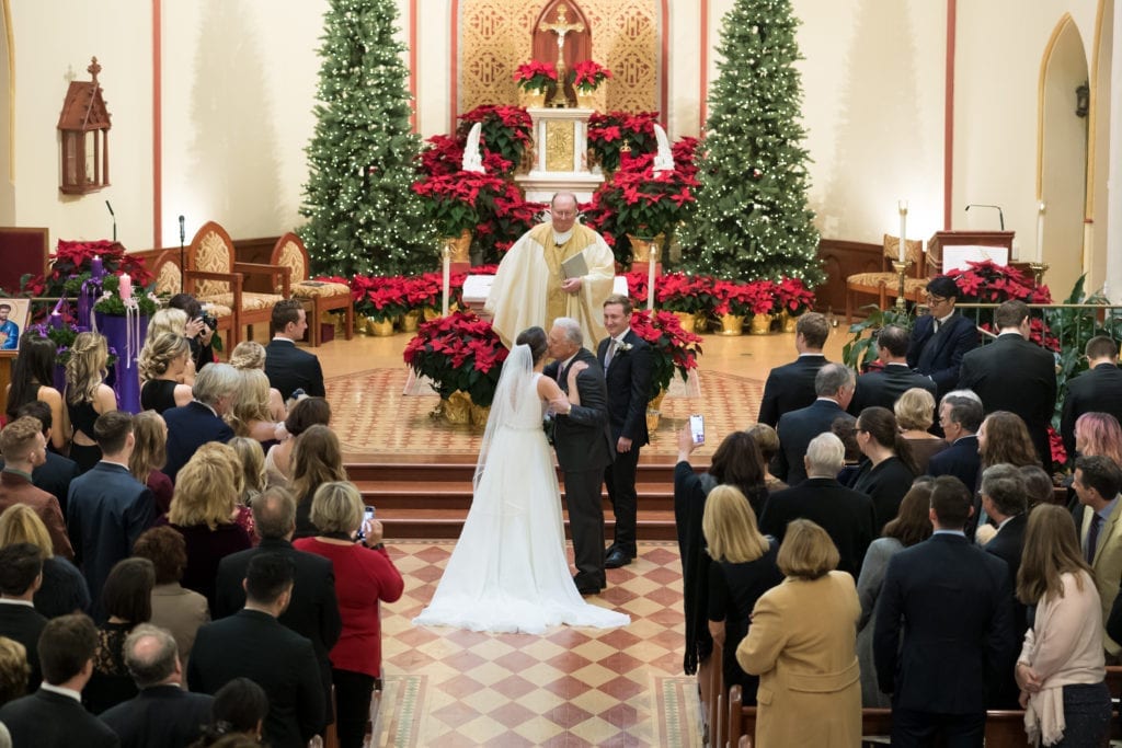 father of bride kissing his daughter before giving her away