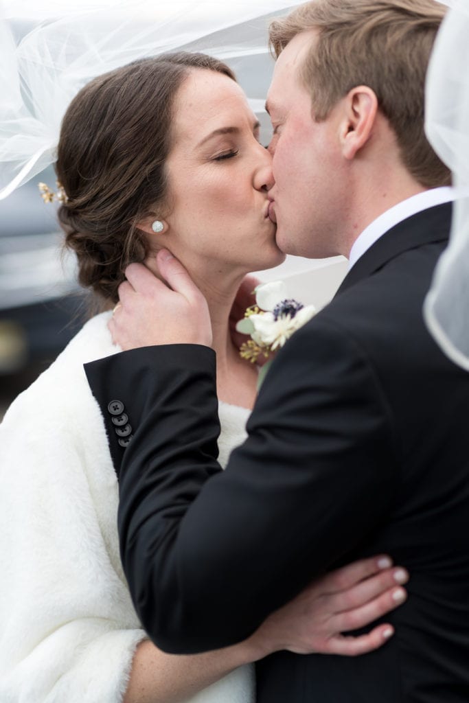 bride and groom kissing after wedding