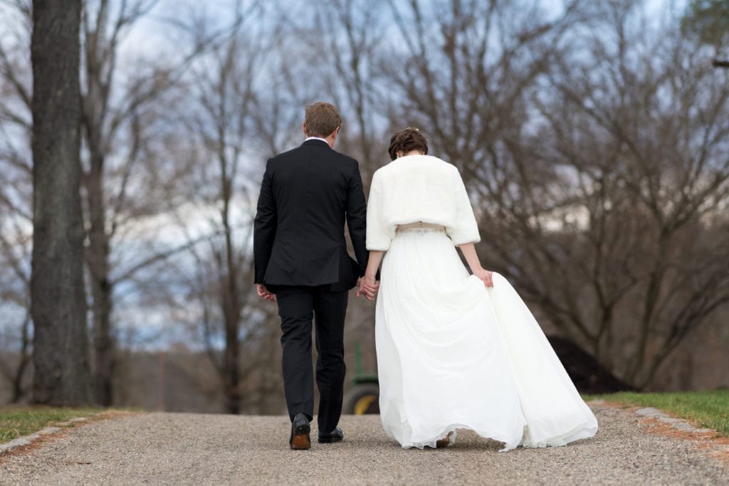 bride and groom walking along the road