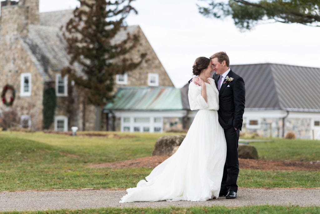 bride in fur stole with groom outside of country club