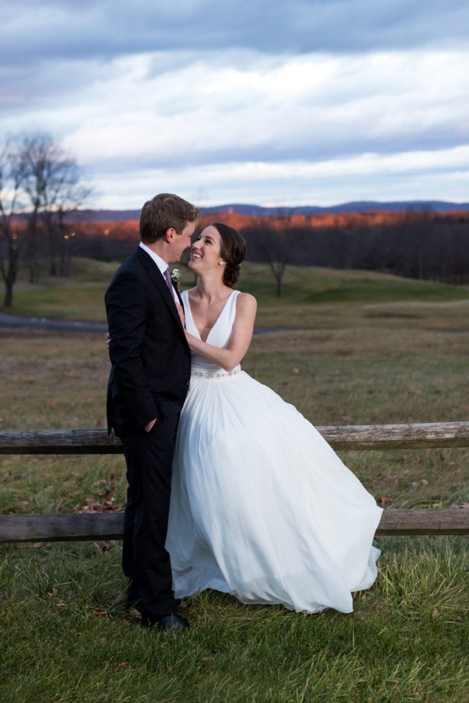 bride and groom with the sprawling country club grounds behind them