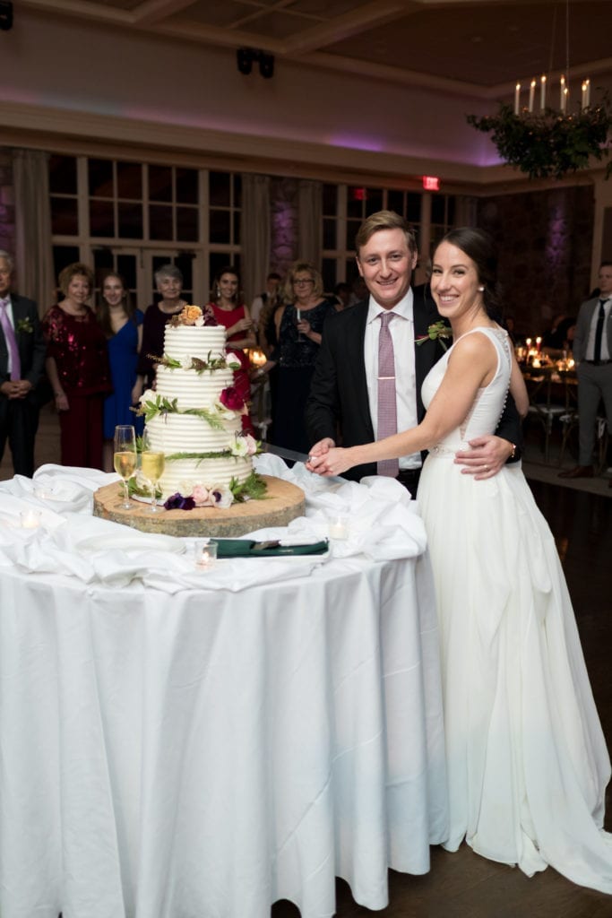 bride and groom cutting their cake