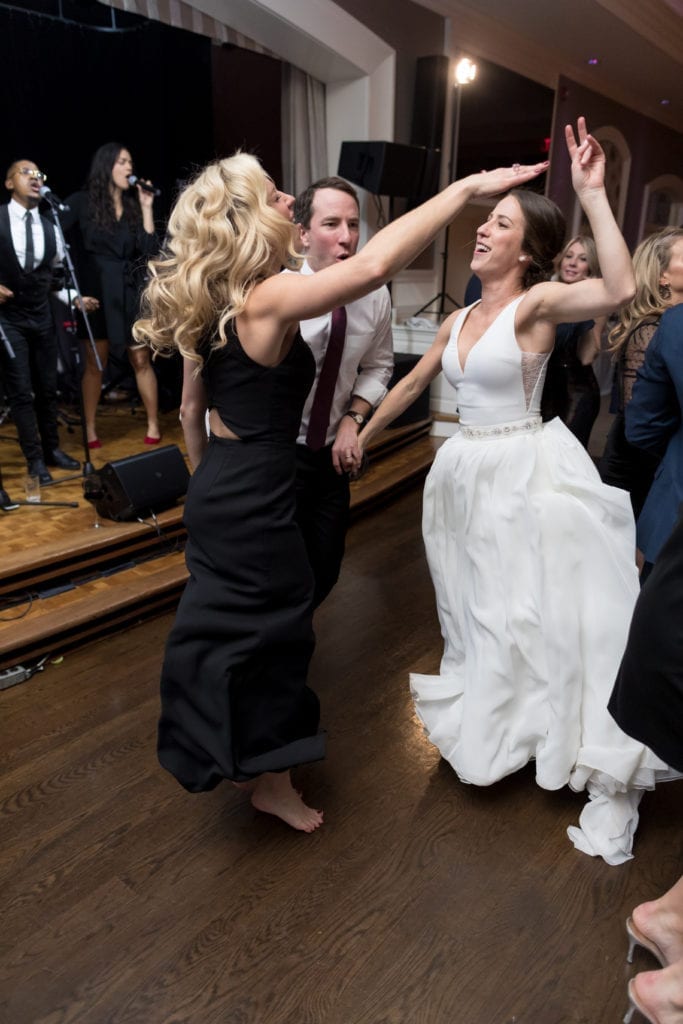 bride and groom dancing with maid of honor