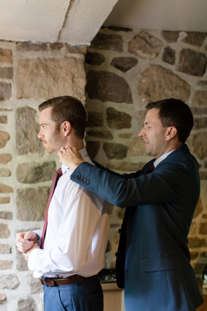 grooms father helping him get ready