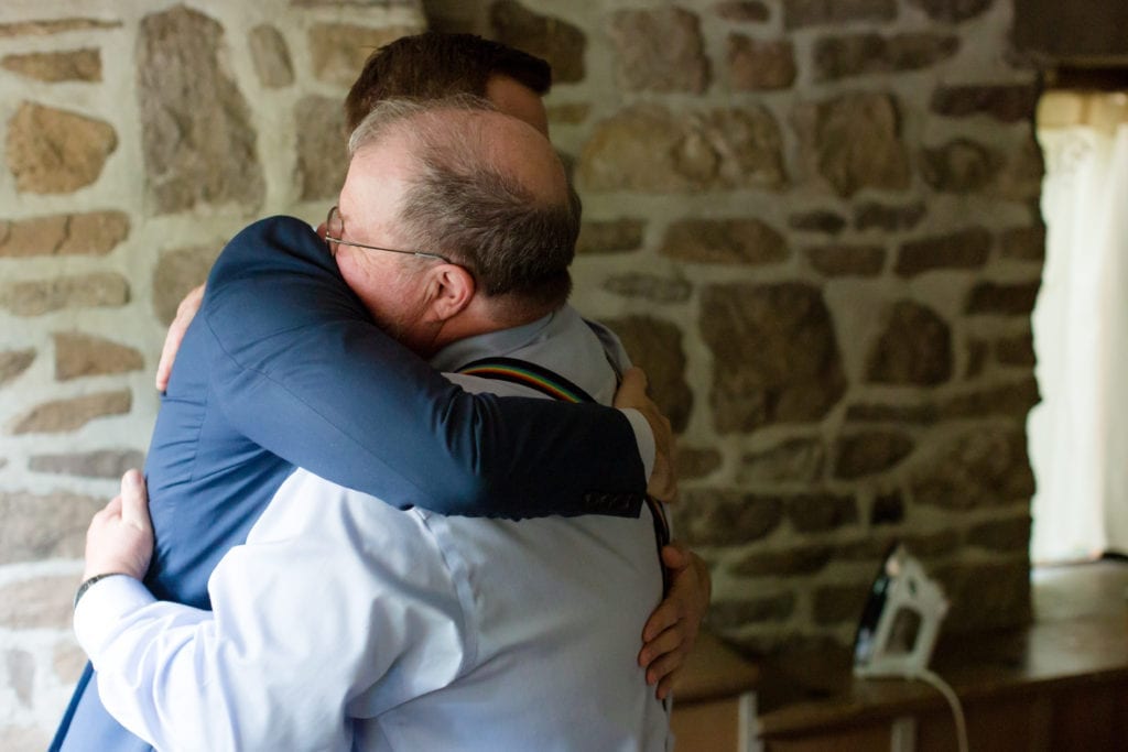 groom hugging a family member