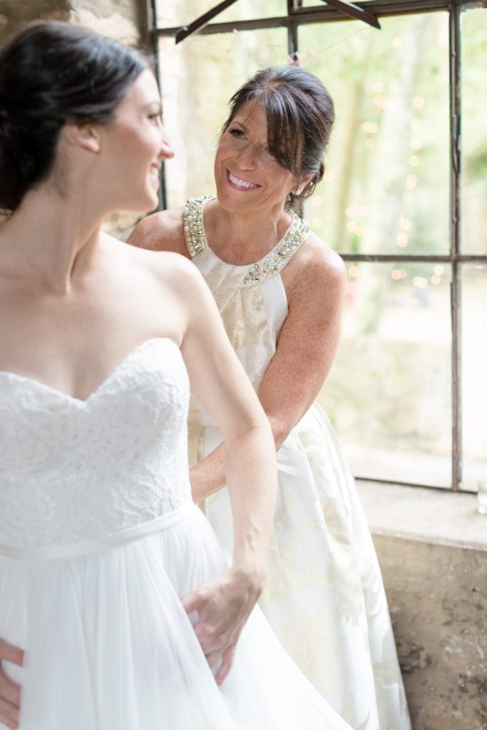 brides mother helping her get ready