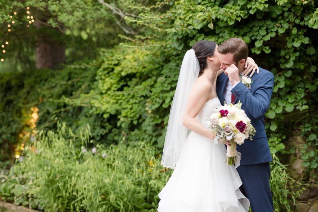 groom wiping away a tear as he first sees his bride