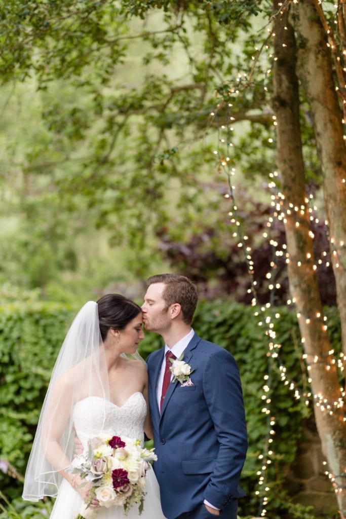 groom kissing his bride on the forehead