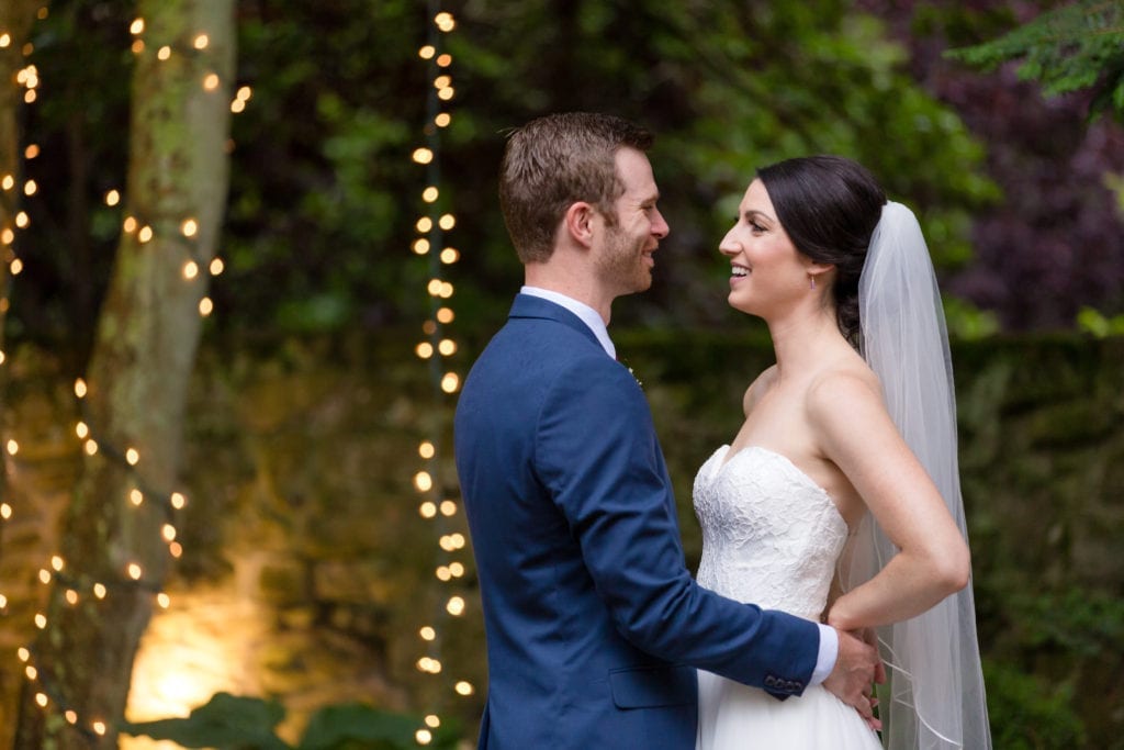 groom with his arms around his brides waist