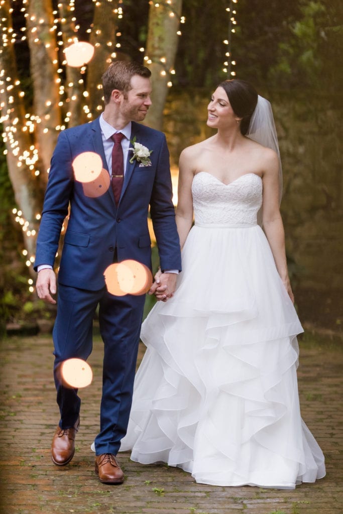 bride and groom walking hand in hand