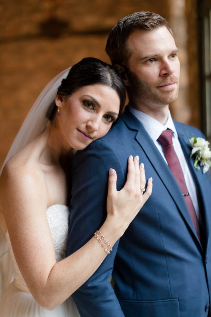 bride on her grooms shoulder