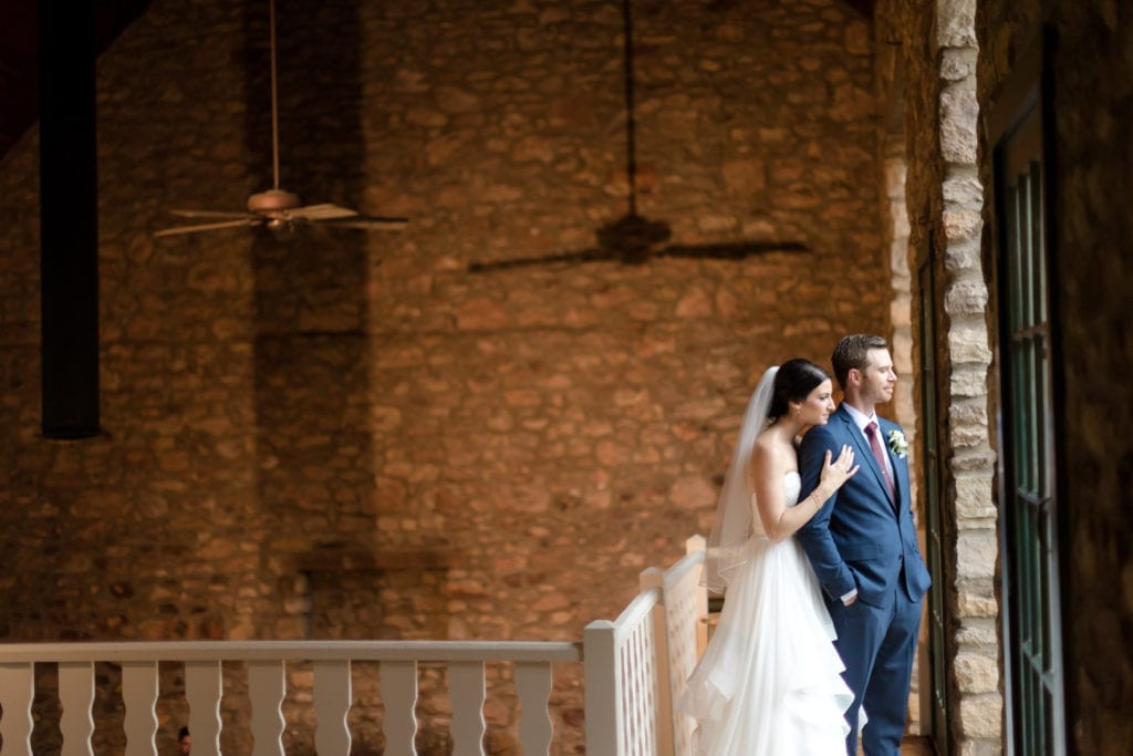 bride and groom on balcony of holly hedge estate