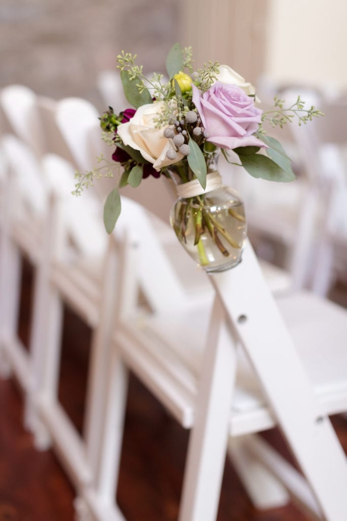 floral arrangements on wedding ceremony chairs