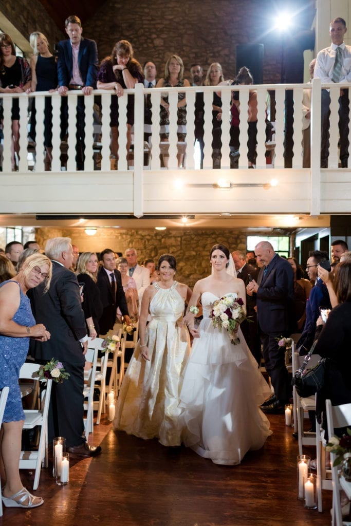 bride walking down the aisle with her mother