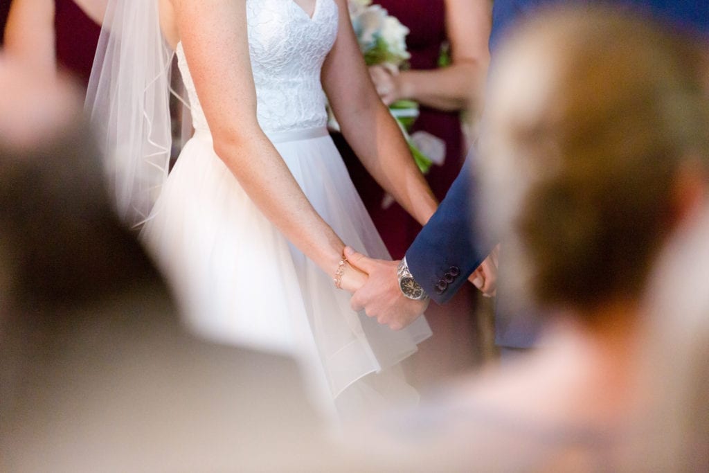 bride and groom holding hands