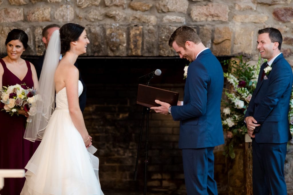 groom reading his bride his wedding vows