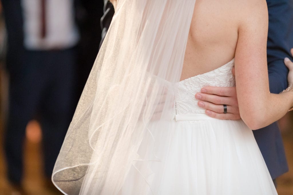 groom holding his bride tight during first dance