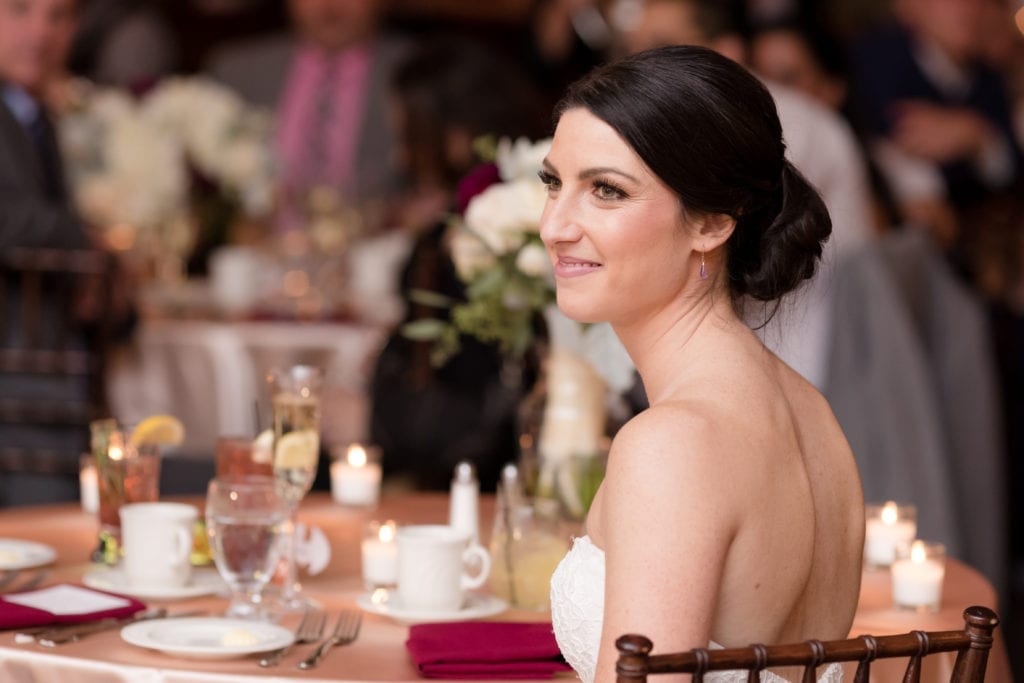 bride listening to wedding speeches