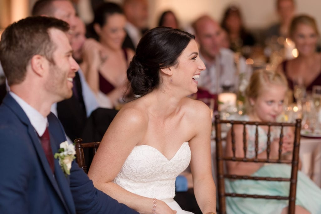 bride and groom laughing at their speeches