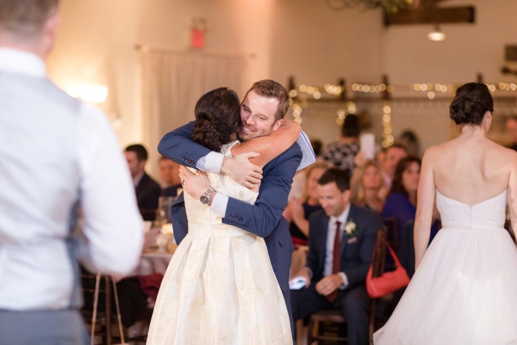 mother of the bride hugging groom