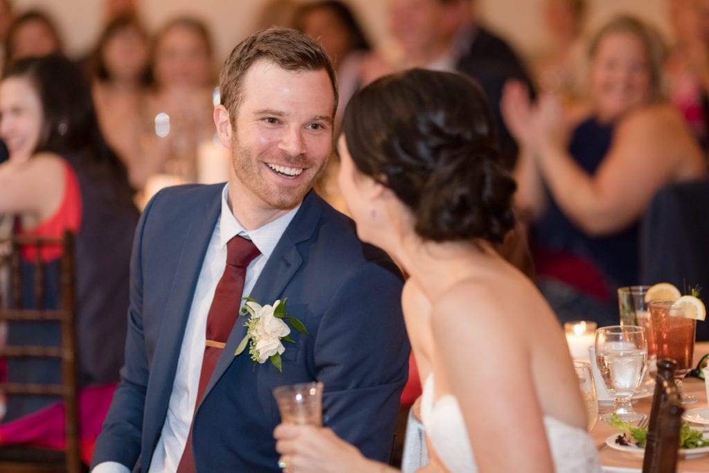 bride and groom smiling at wedding reception at holly hedge estate