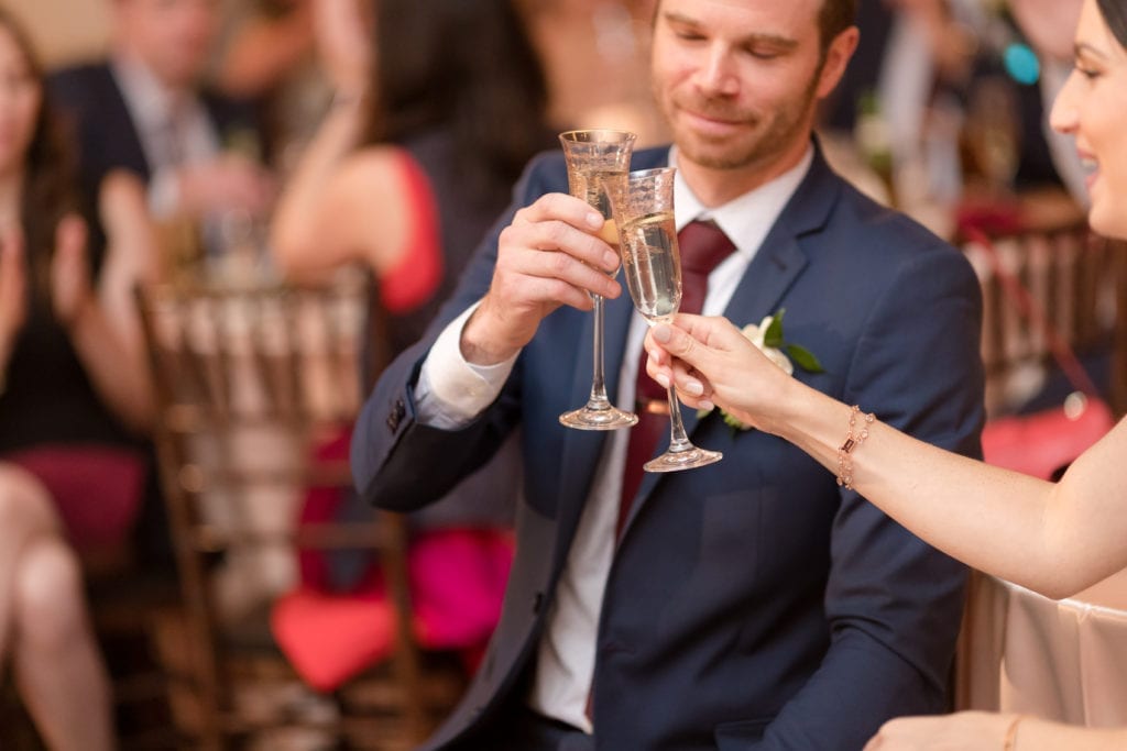 bride and groom toasting to their wedding