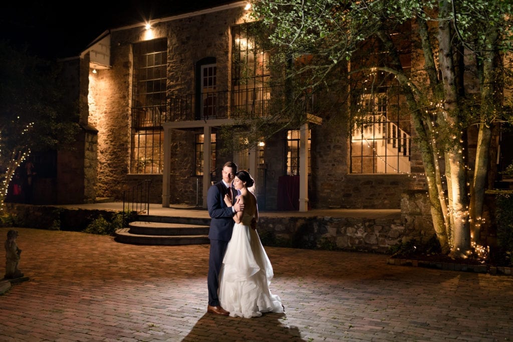 shot of bride and groom in front of holly hedge estate