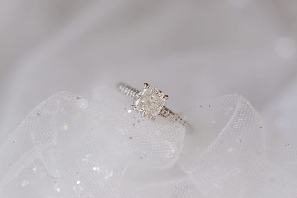 cushion cut diamond engagement ring on brides veil