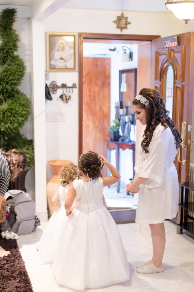 bride admiring her flower girls in their Joan Calabrese dresses