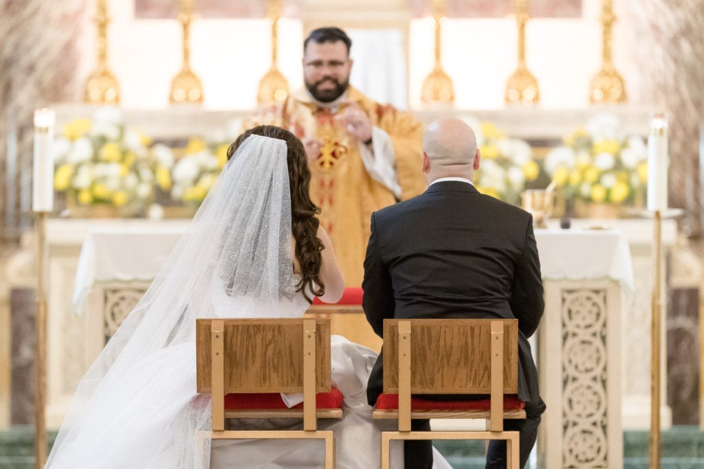 bride and groom sitting at their wedding ceremony