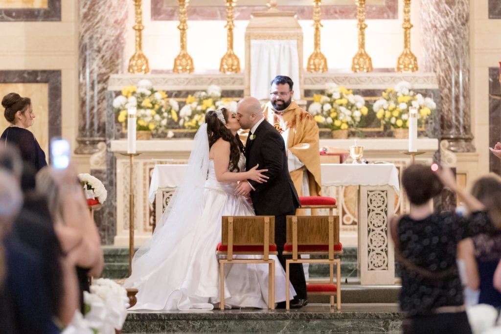 bride and grooms first kiss