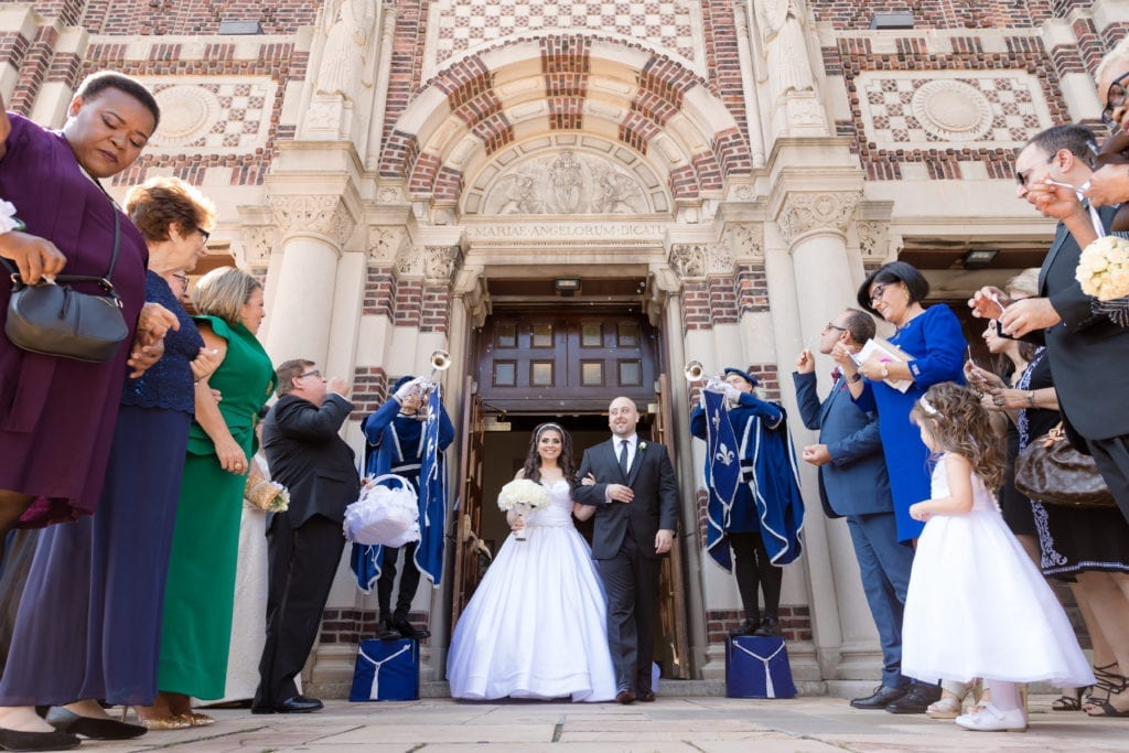 bride and groom being received by their guests outside of their wedding ceremony