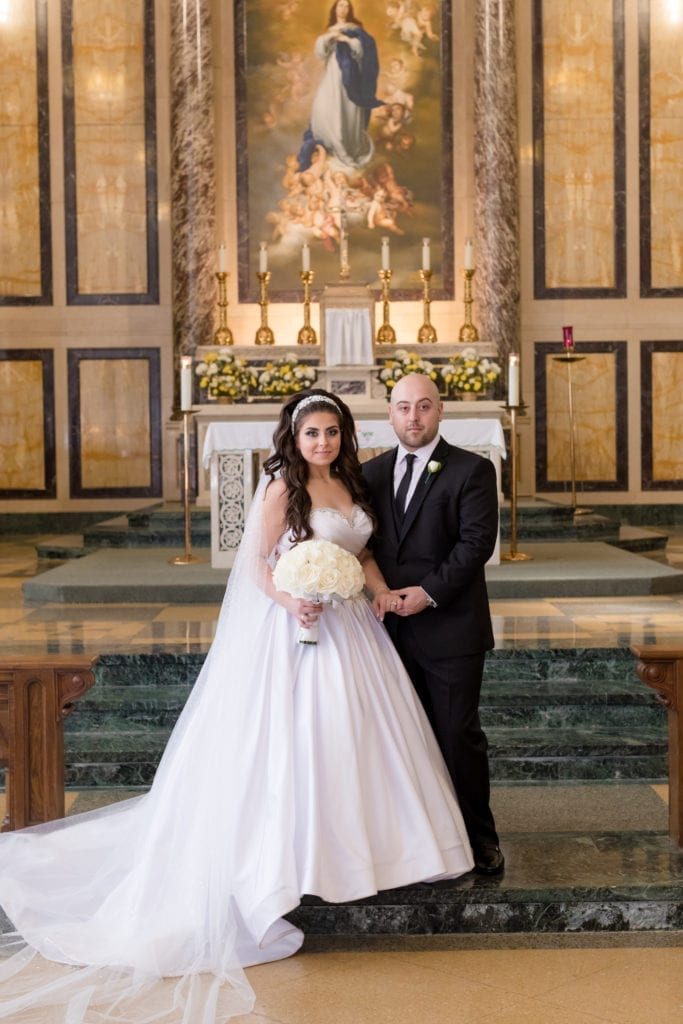 bride in her Pnina Tornai wedding dress with groom at their ceremony