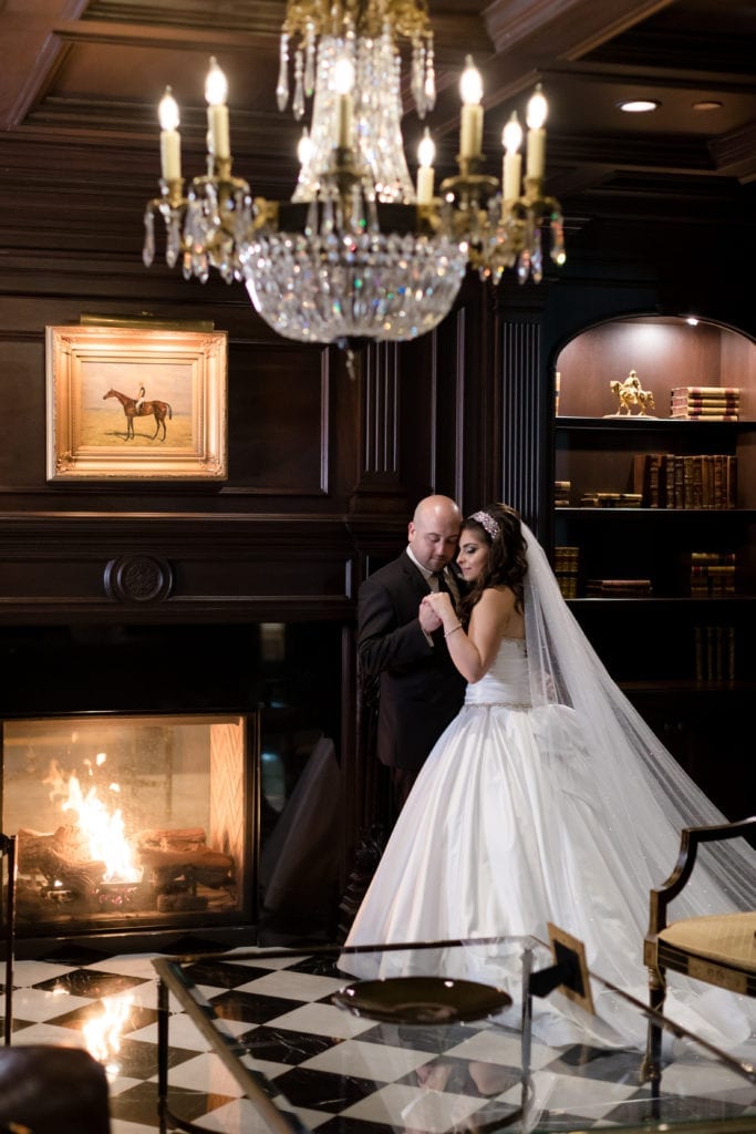 bride and groom in the library of Park Chateau