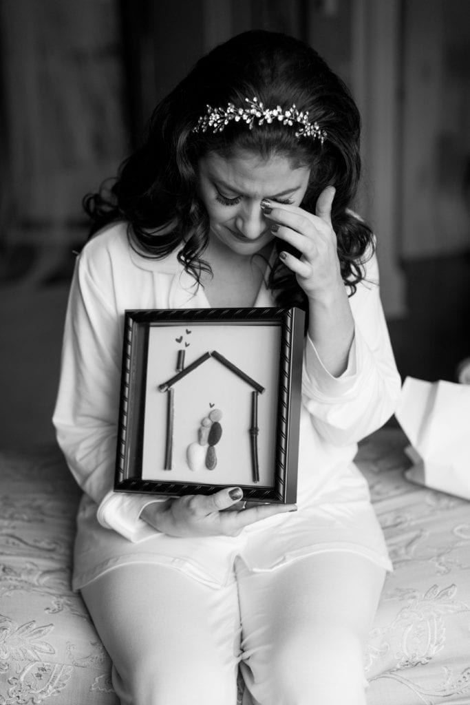 bride shedding a tear over a sentimental wedding gift