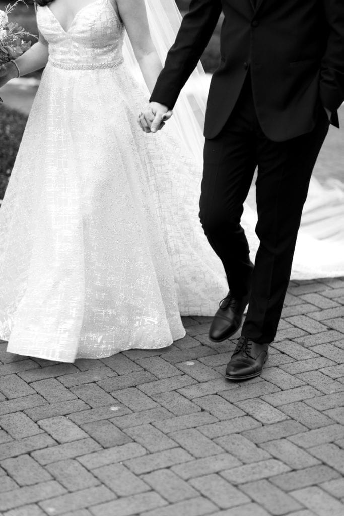 bride and groom holding hands