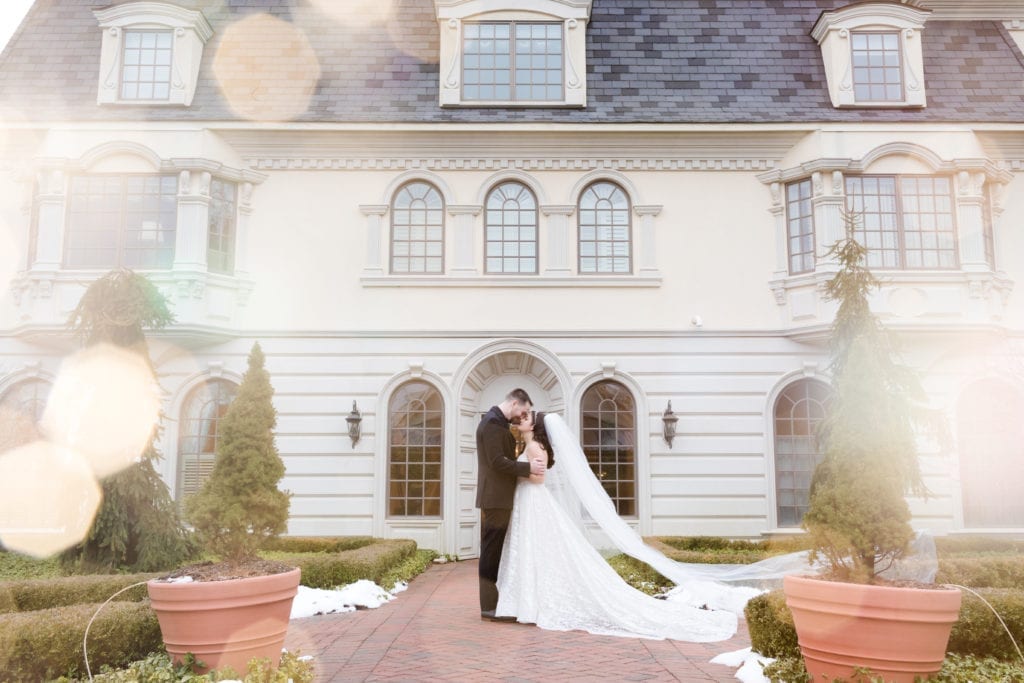 bride and groom kissing outside of ashford estate