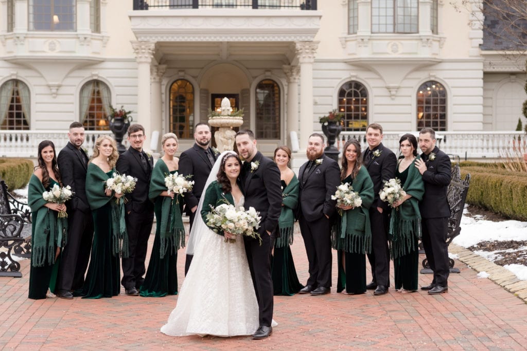 bride and groom front and center with wedding party behind them