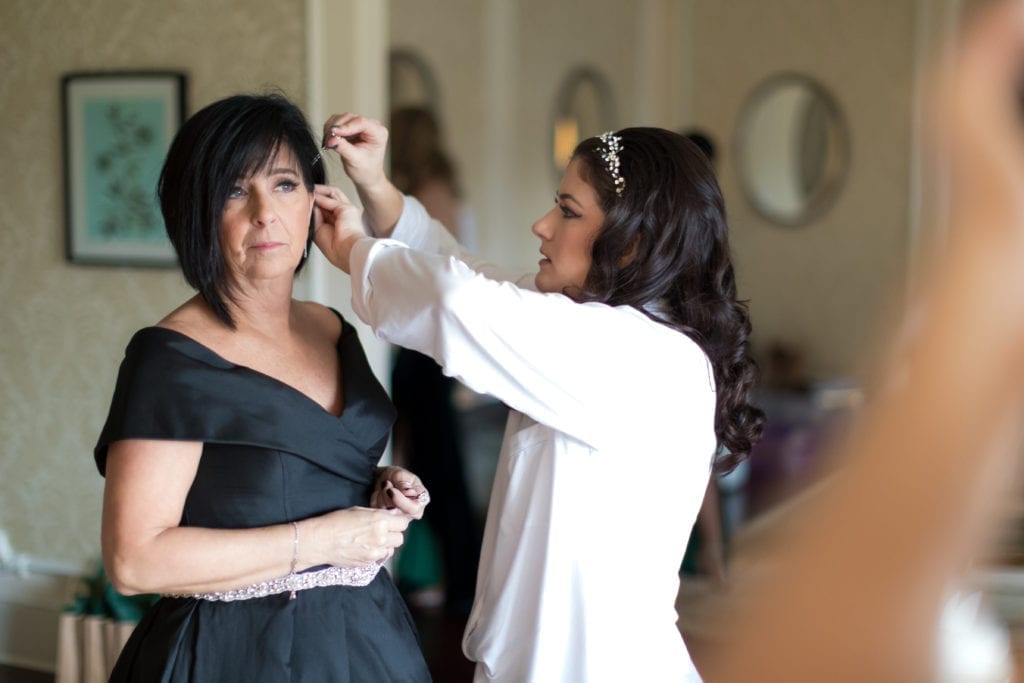 bride helping her mother do her hair