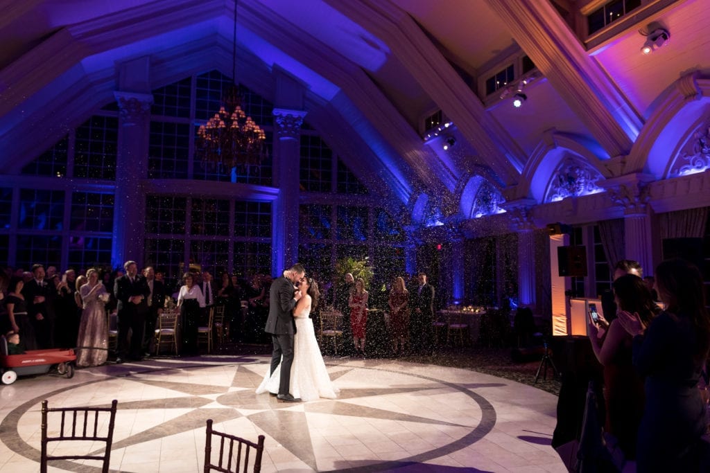 bride and grooms wedding guest watching them share their first dance