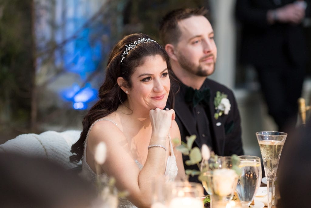 bride and groom listening to their speeches